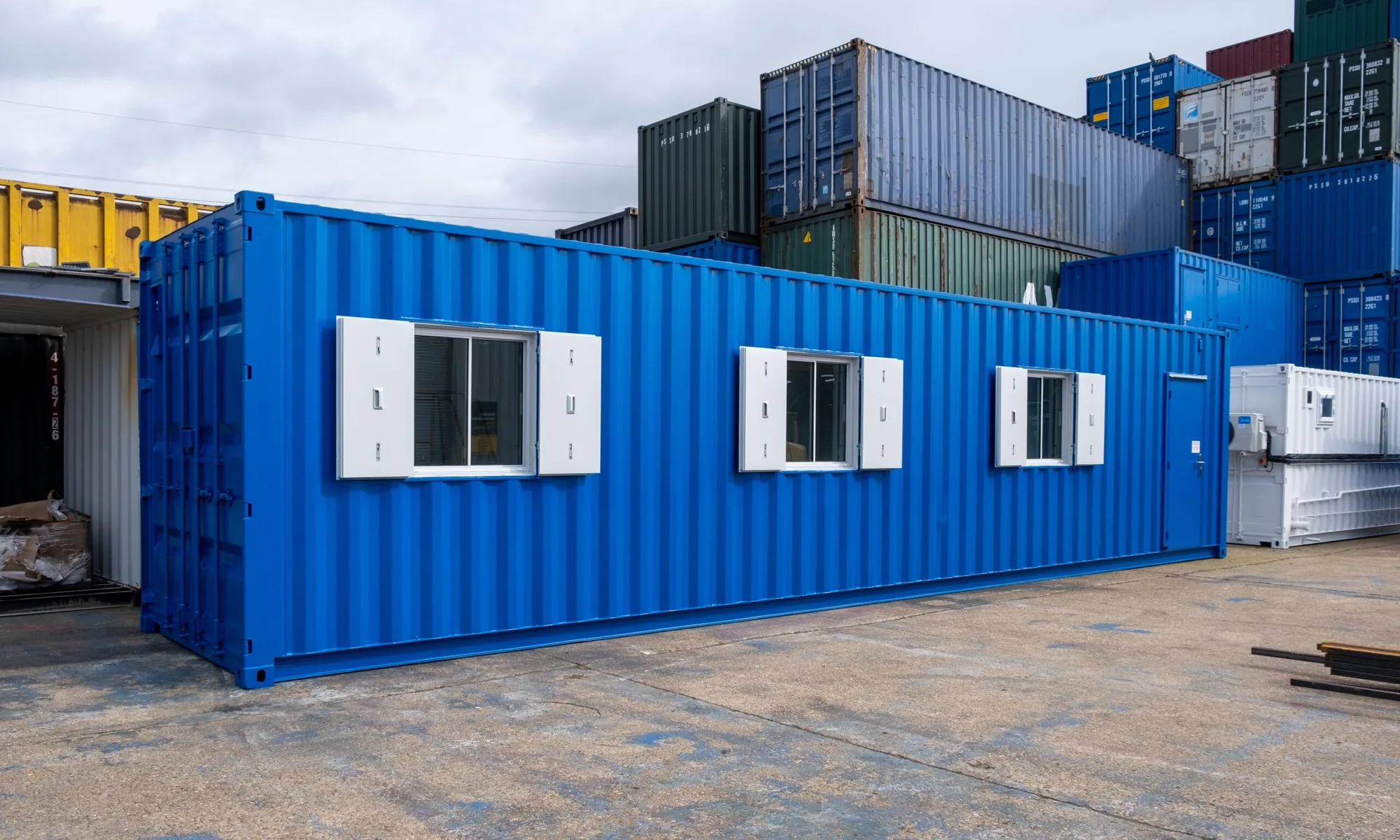 Blue 40ft container conversion with shuttered windows
